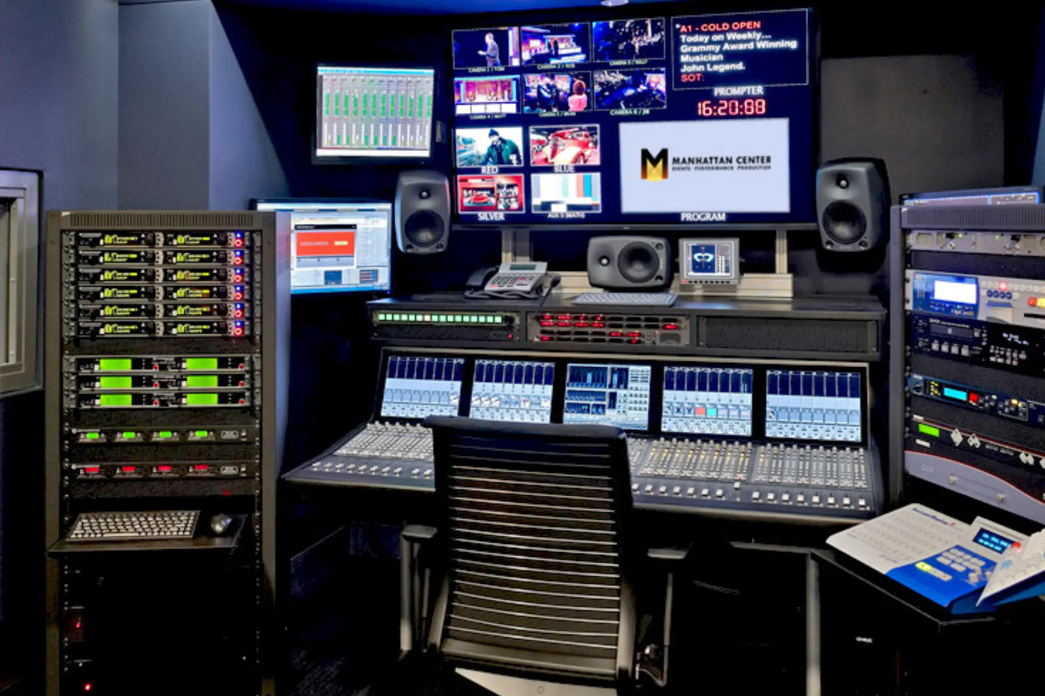 A modern television control room featuring audio equipment, multiple screens, and a central mixing console, ready for production A modern television control room featuring audio equipment, multiple screens, and a central mixing console, ready for production